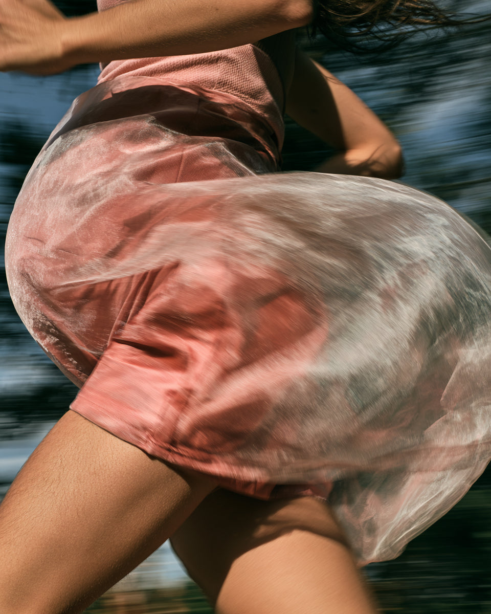 Close-up of a pregnant woman's torso in motion